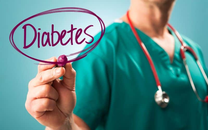 Image of a vet writing the word diabetes in red pen and encircling the word twice