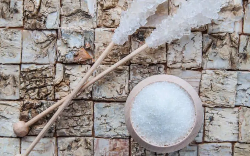 Image of powdered xylitol and crystallised xylitol on a stick