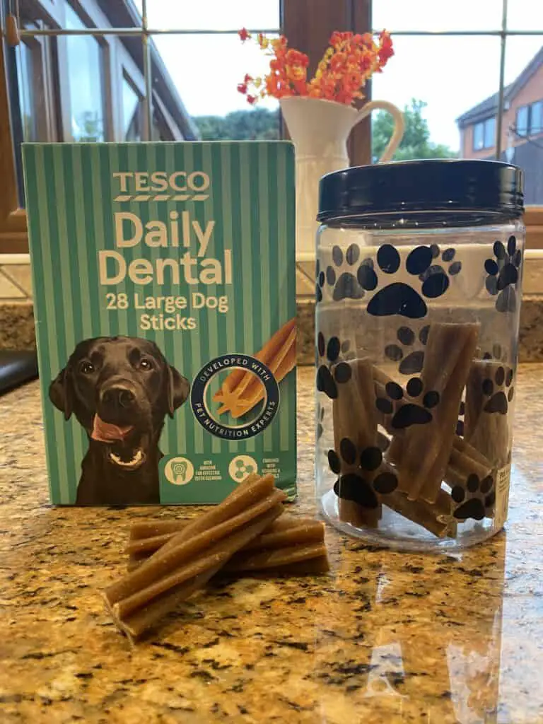 Cheap store-branded dog chews next to a pot containing the chews cut in half