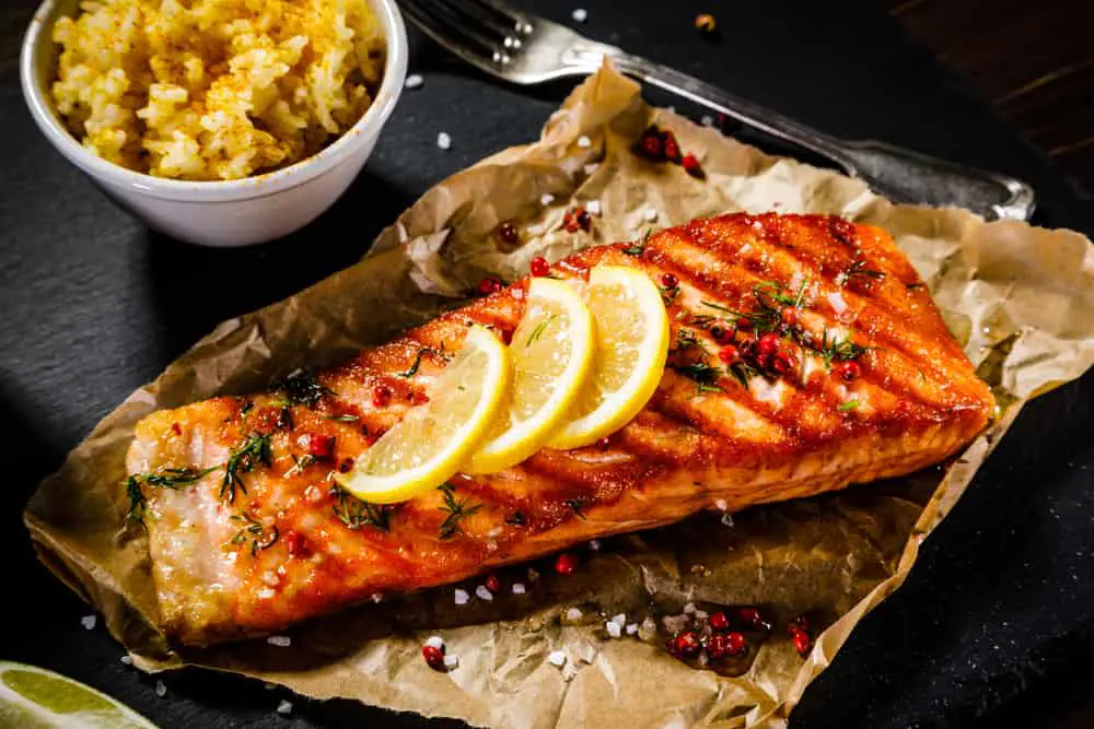 Grilled,Salmon,With,Vegetables,Served,On,Black,Stone,Plate