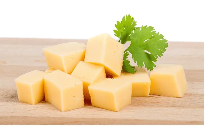 Cheese cubes on a cutting board